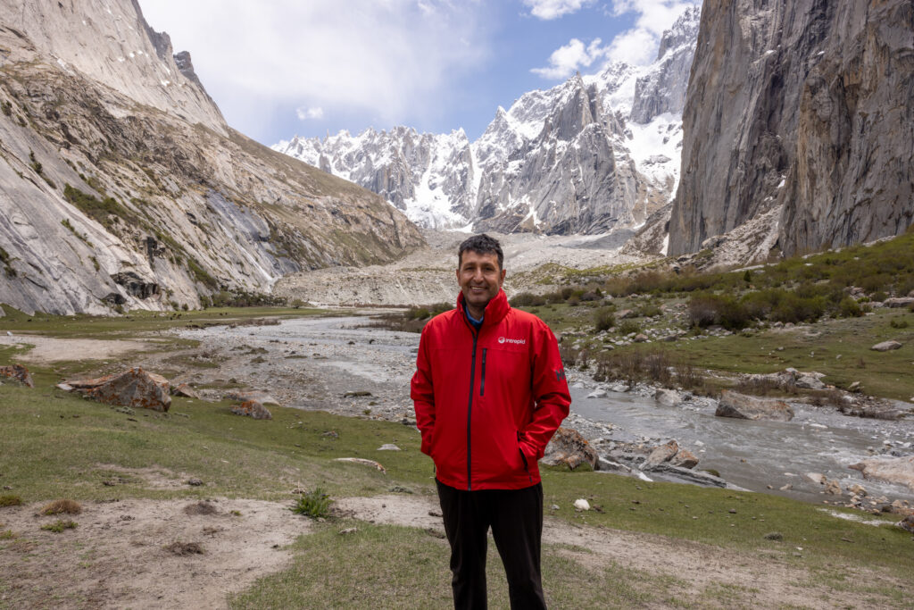 Muneer Alam, Beyond the Valley lead guide, standing at the granite amphitheatre in the Karakoram mountains
